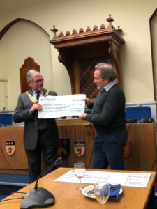 The photo shows the cheque being presented by the Mayor, Paul Ward, to Tony Rose, Chair of the trustees at Tavistock Museum.